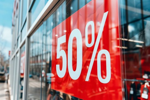 Red sale sign with text '50%' in shopping window. Generative AI, AI generated