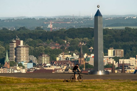 View of the city centre, skyline of Herne, over the Hoheward spoil tip, obelisk of the sundial,