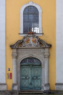 Entrance portal to the monastery church of St Hedwig, 1755, above the alliance coat of arms of the
