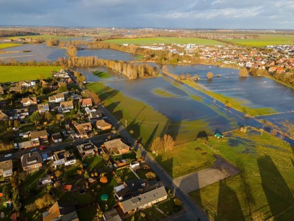 Aerial view of residential area next to lakes due to flooding, under cloudy sky, Christmas, 2023,