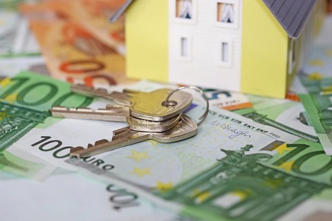 Concept photo with model house, euro notes and coins