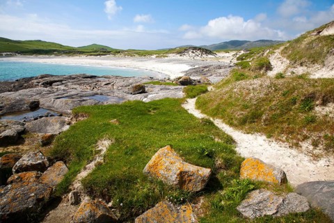 Rocky headland and sandy beach at Bagh a Deas, South Bay, Vatersay island, Barra, Outer Hebrides,