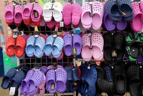 Display of colourful children's plastic Croc beach footwear at the seaside town of Cromer, north
