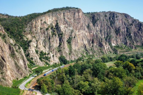The Rotenfels with an Alstom Coradia LINT regional train operated by Vlexx in Traisen, Germany,