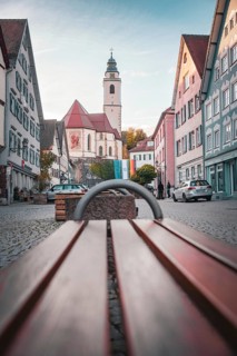 Old town with church and bench on cobblestones in the morning light, Horb, Black Forest, Germany,