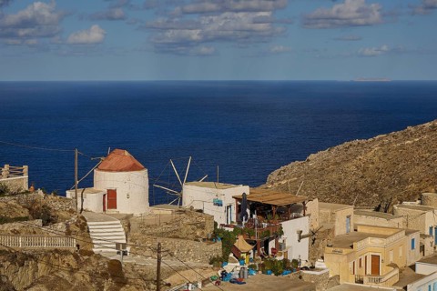 Rustic coastal village with windmill and direct sea view, Mediterranean charm, Colourful mountain