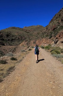 Woman walking along coast path in Cabo de Gata national park, near San José, Almeria, Spain, Europe