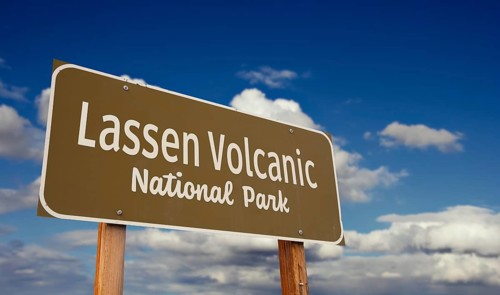 Lassen volcanic national park (california) road sign against blue sky and clouds