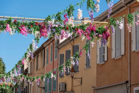 Colourful garlands of flowers hang in the streets of Sainte-Maxime, Provence-Alpes-Côte d'Azur,