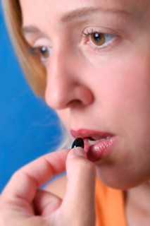 A young woman takes a painkiller, Studio