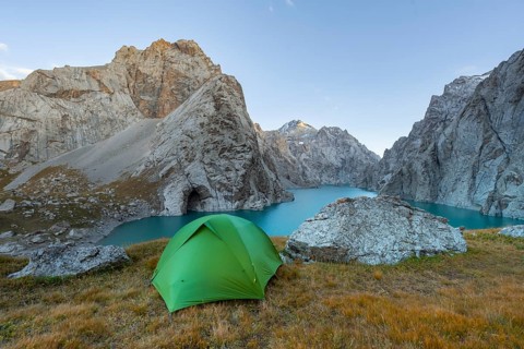 Wild camping, camping in the wilderness with a tent in front of mountain lake Kol Suu, Sary Beles