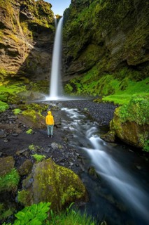 Tourist at Kvernufoss waterfall, in summer when the weather is nice, gorge and river, long