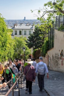 People walking down the stairs and enjoying the view in Montmartre, Paris