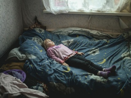 Angelina, 9 years old, on her bed. The village of Borshchivka was under Russian occupation. She has