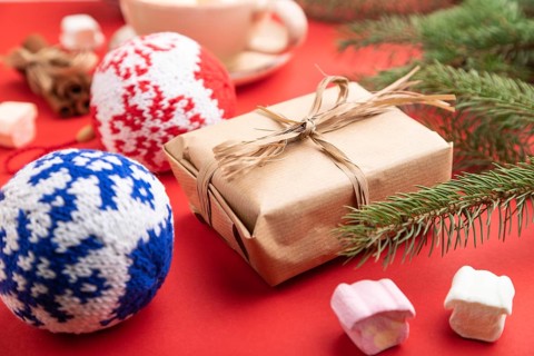 Christmas or New Year composition. Decorations, box, cinnamon, knitted balls, fir and spruce
