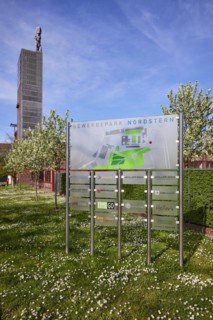 Signpost to the companies in the Nordstern industrial park and the winding tower of Nordstern