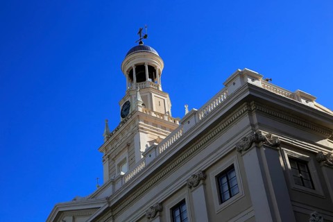 Looking up at tower and blue sky of Ayuntamiento city hall building, Cadiz, Spain, Europe
