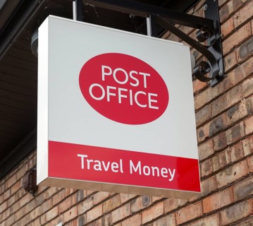 Close up Post Office travel money sign, Woodbridge, Suffolk, England, UK