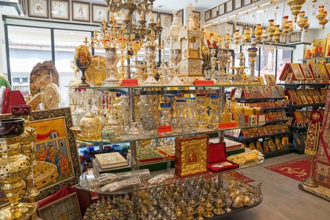 Interior of a shop full of religious artefacts with icons and candlesticks, Ouranoupoli, City of