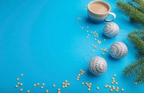 Christmas or New Year composition. Decorations, silver balls, fir and spruce branches, cup of