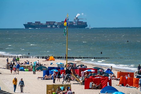 Beach of Domburg, in Zeeland, South Holland, Netherlands, in the background a container freighter