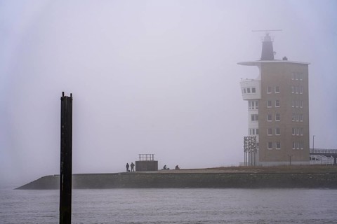 Thick fog in winter, hanging over the mouth of the Elbe into the North Sea, radar tower of the
