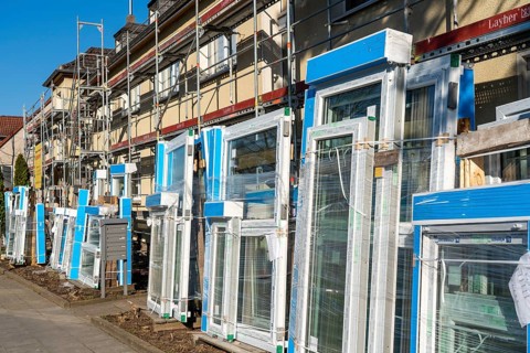 Energy-efficient refurbishment of residential buildings, older apartment block is scaffolded, gets