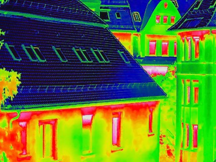 Apartment block, facade of a residential building with windows. Thermal image or thermography,
