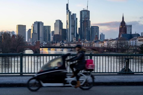 Skyline of the city centre of Frankfurt am Main, cargo bike cyclist on the Ignatz-Bubis-Bridge,