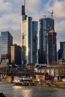 Skyline of the city centre of Frankfurt am Main, river Main, Eiserner Steg bridge, freighter, dusk,
