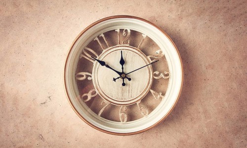 Mechanical wall clock, transparent, beige color, on a light painted wall, rustic style, vintage, no
