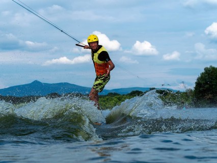 Man jumping with wakeboard, water sports, water skiing and wakepark