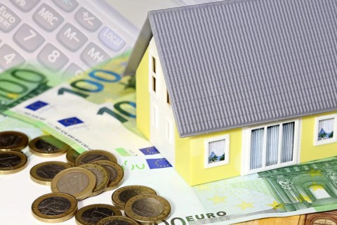 Concept photo with model house, euro notes and coins