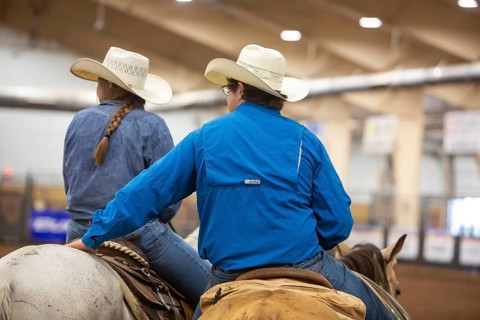 Oklahoma City, Oklahoma, Two riders on their horses watch the competition at the Great Plains Rodeo