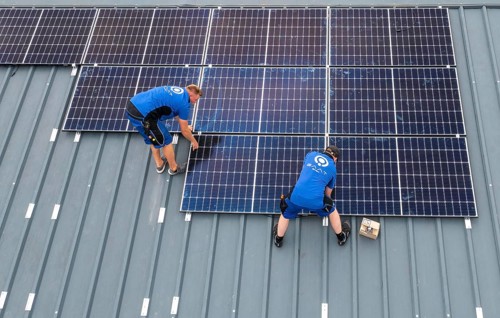 Installation of solar modules on the roof of a barn on a farm, over 240 photovoltaic modules are