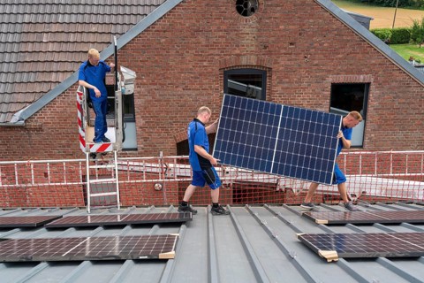 Installation of solar modules on the roof of a barn on a farm, over 240 photovoltaic modules are