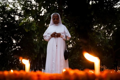 A Nun offer prayers on the grave during the All souls day observation, in Guwahati, India on 2