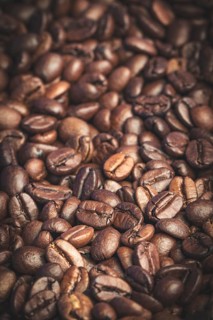 Close-up of roasted, aromatic coffee beans in various shades of brown
