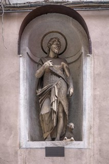 Sculpture of Juesu with the lamb, in a niche on the façade of a residential building, Genoa, Italy,