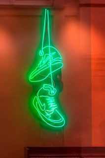 Trainers as illuminated advertising in a sports shop, Genoa, Italy, Europe
