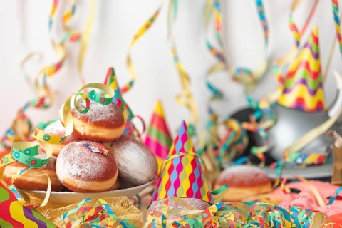 Carnival atmosphere with party hats and doughnuts on a table