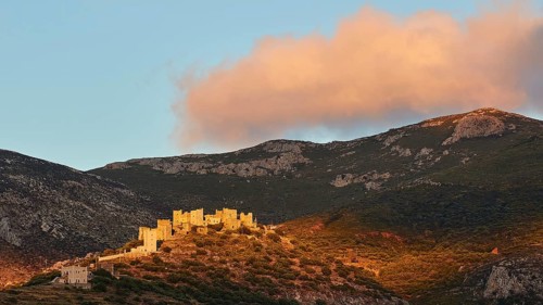 Majestic historic buildings illuminated by the last evening sun on a hilltop, Vathia, residential