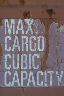 Close-up of maximum cargo cubic weight holding capacity indicated on outside of shipping container,
