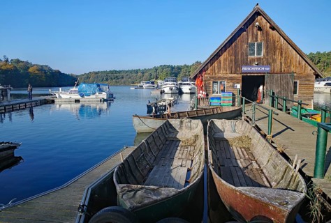 Harbour with boats and wooden hut, surrounded by calm water and nature, Eldenburg, Tourism, Waren