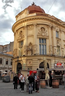 Bucharest, city centre, building in the old town and in front of it a sausage stand, Romania,