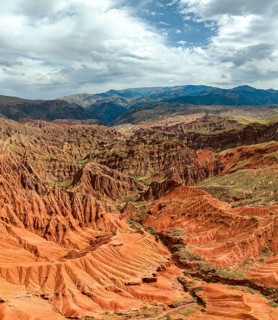 Eroded mountain landscape, canyon with red and orange rock formations, aerial view, Konorchek