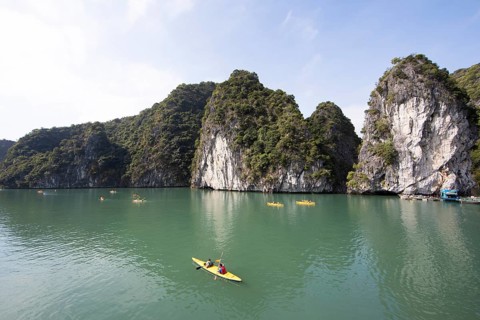 Kayakers and the karst rocks in Lan Ha Bay, Halong Bay, Vietnam, Asia