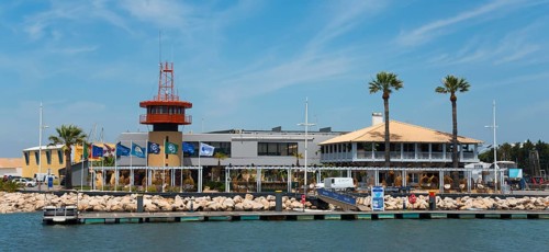 Harbour view with buildings and palm trees on a sunny day, Vilamoura, Faro, Algarve, Portugal,