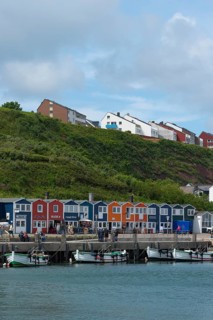 Colourful lobster shacks on the promenade in the lowlands, boats, offshore island of Heligoland,