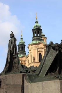 Jan Hus Monument on the Old Town Square and the towers of St Nicholas Church, Prague, Czech